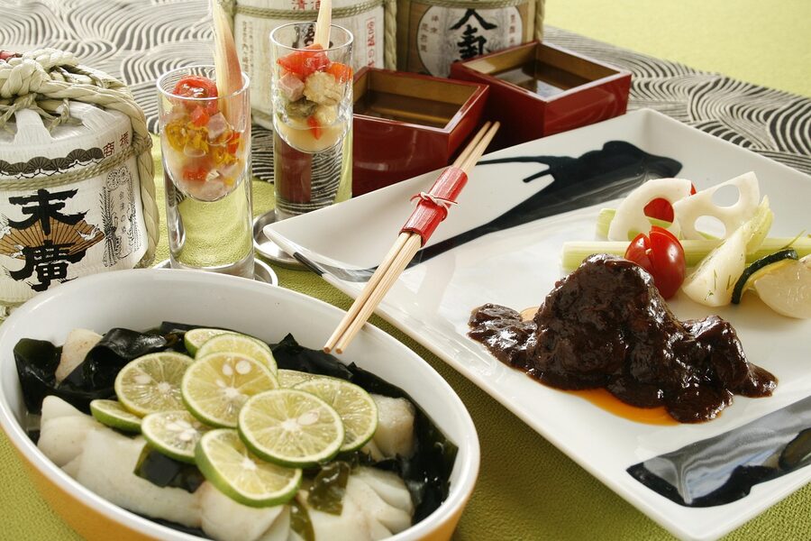 Simmered fish dish prepared with sake on a Japanese dinner table, classic atsukan pairing