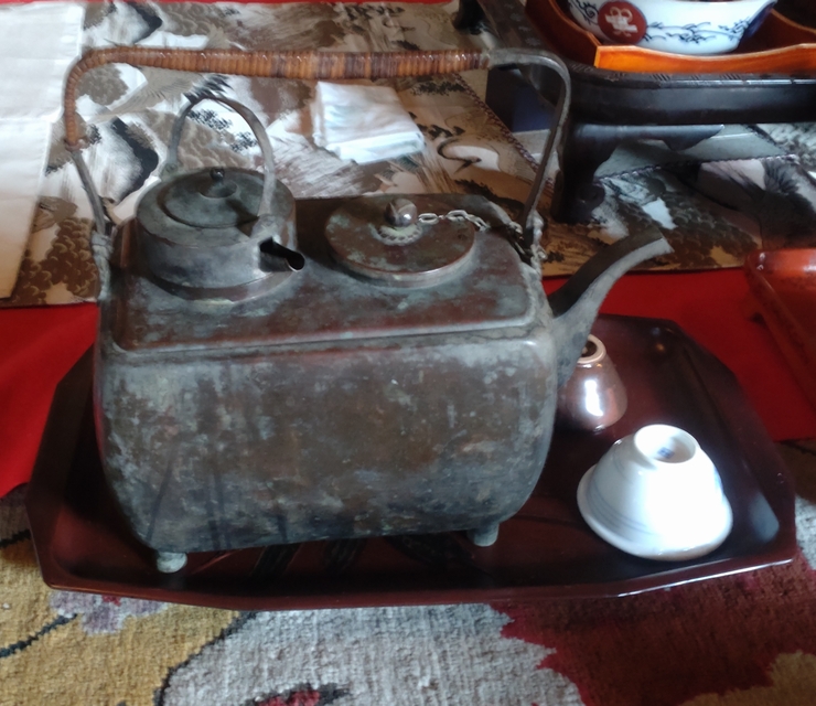 Traditional equipment for heating hot sake at the Kobayashi House, including a copper kansuke water bath