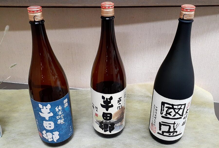 A row of Nakano Sake Brewery bottles displayed at a brewery in Aichi Prefecture, Japan