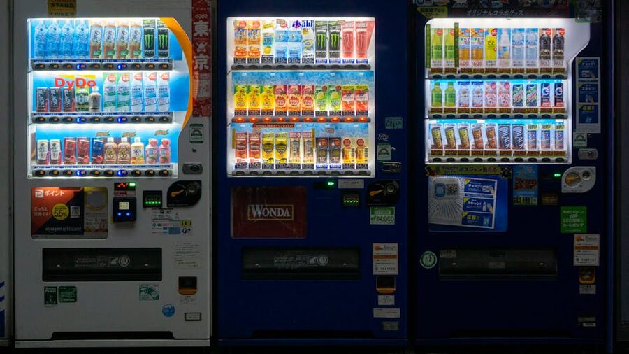 Illuminated drink vending machines on a Tokyo street at night in Taito ward