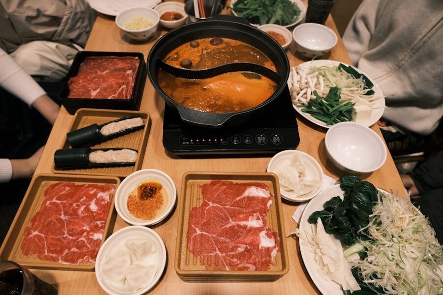 Japanese hotpot meal with assorted ingredients on a restaurant table