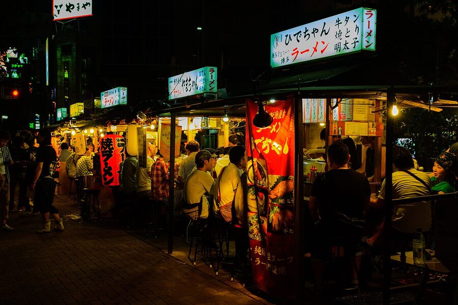 Row of red-canopied Nakasu yatai stalls glowing at night, Fukuoka