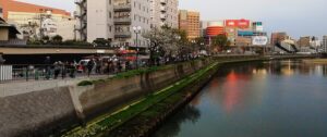 Row of yatai stalls glowing along the Naka River in Nakasu, Fukuoka