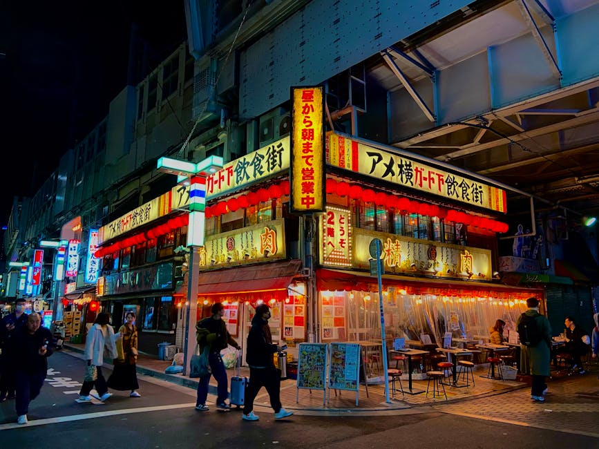 Lively narrow yokocho-style night alley in Japan with neon and lanterns