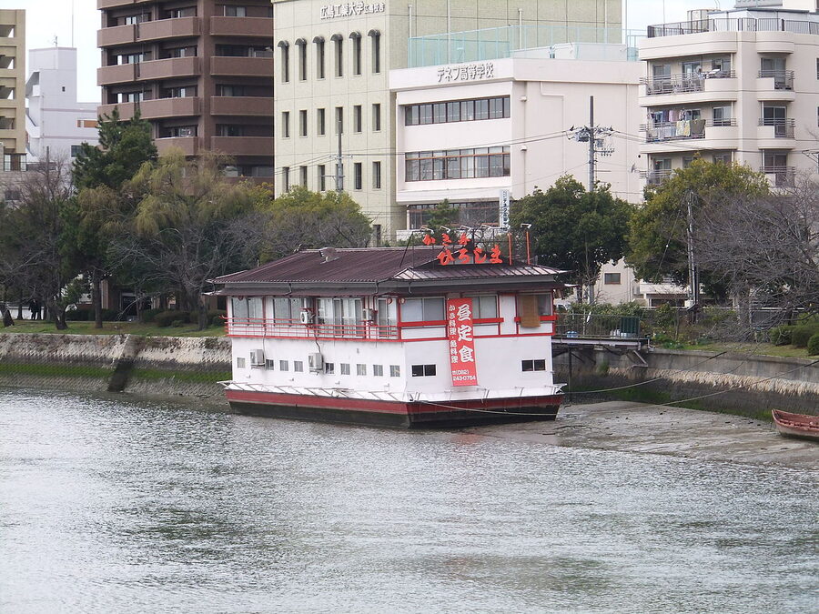Kakibune oyster boat with red roof moored on the Hiroshima riverside