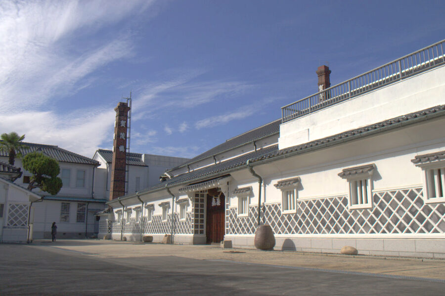 Kamotsuru sake brewery exterior in Saijo with white walls and tile roof