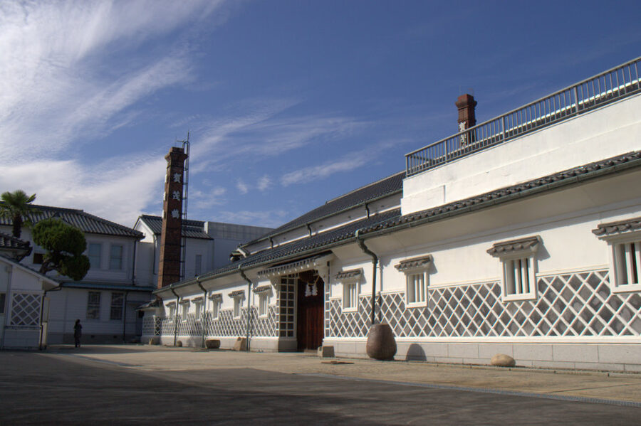 Kamotsuru storefront on Saijo sake brewery street with traditional kura architecture