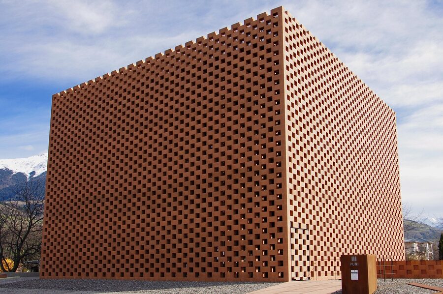 Modern brick distillery building lit up at night