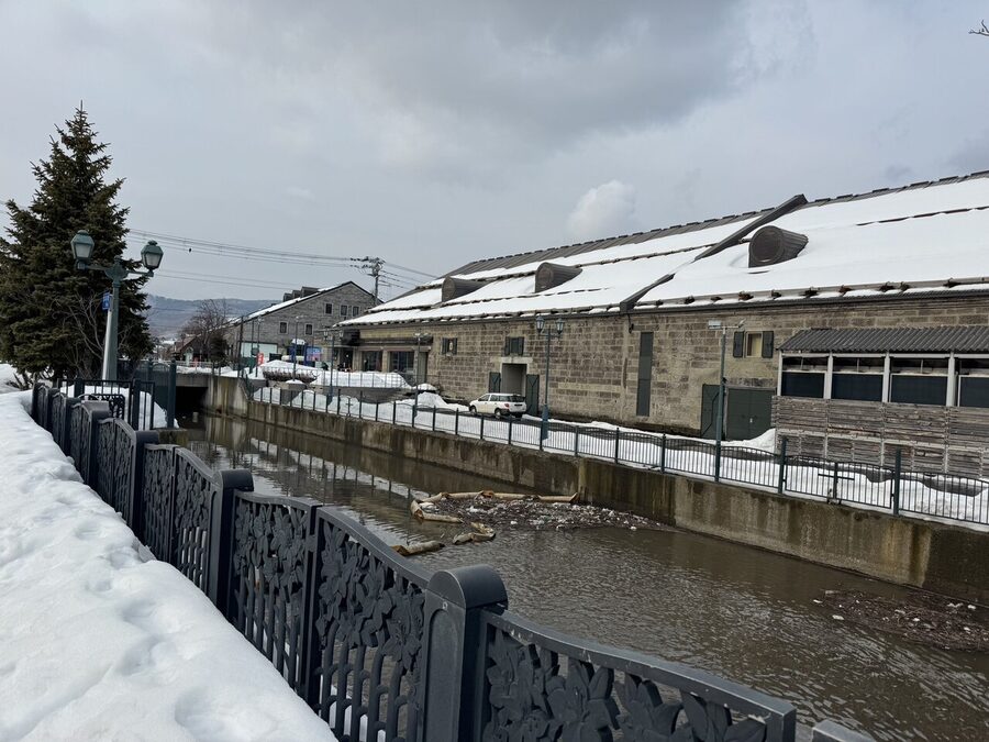 Otaru canal in snow with brick warehouses and street lamps