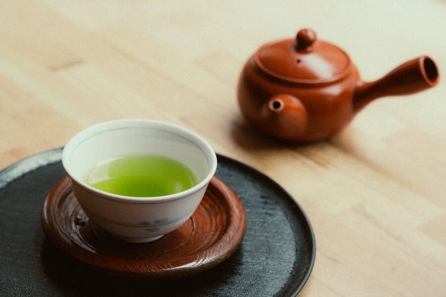 Green tea cup and traditional teapot