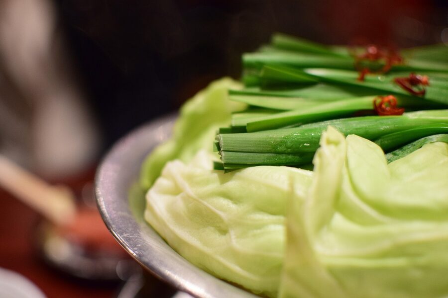 A bubbling pot of motsunabe offal hotpot with miso broth and vegetables, Fukuoka style