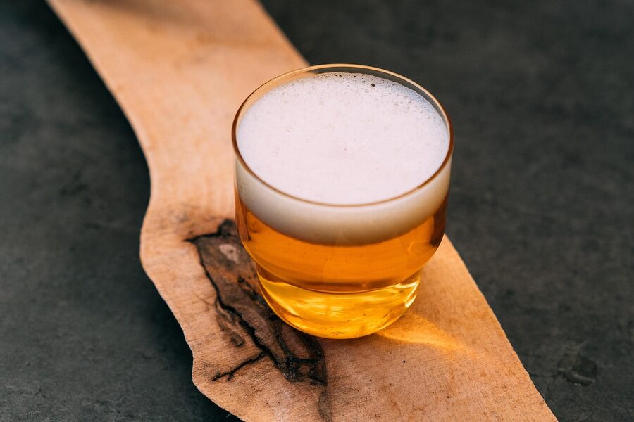 Flight of craft beers in pint glasses on a wooden bar
