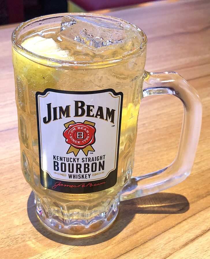 A craft highball in a thin-walled glass with a single ice column