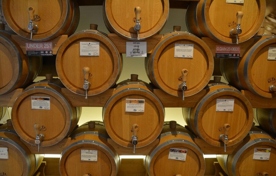 Whisky barrels aging in a wooden warehouse