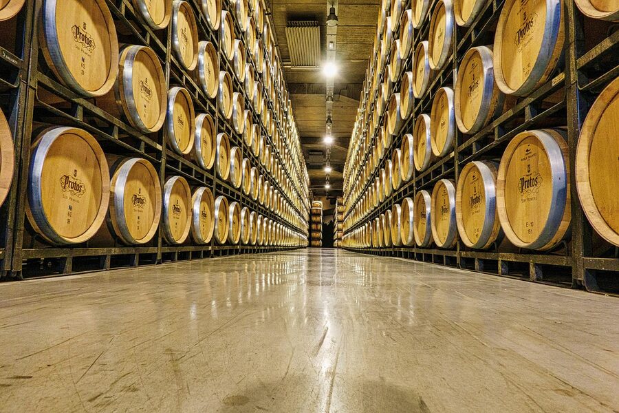 Stacked whisky barrels in a warehouse