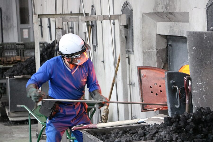 Coal being added to a pot still at Yoichi