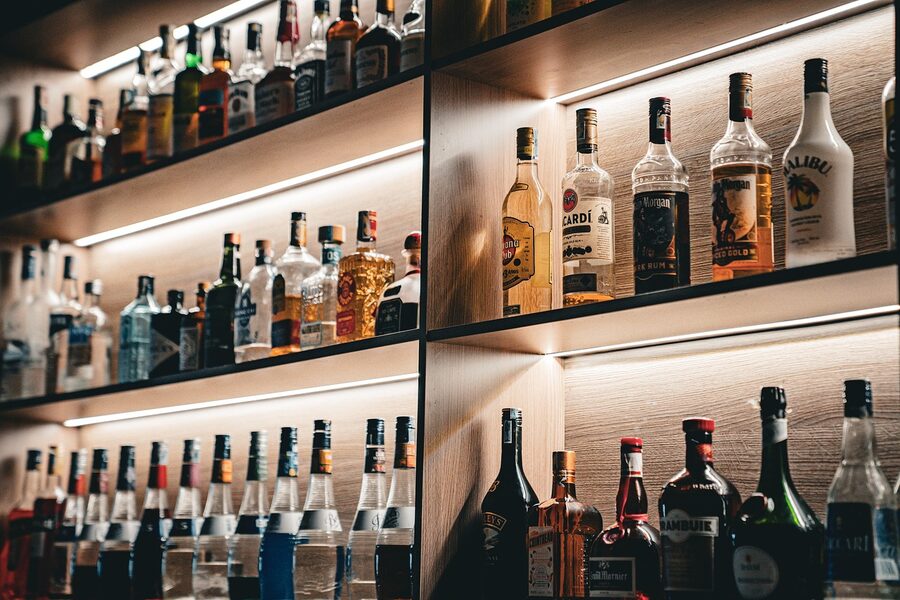 Bar bottles on lit shelf