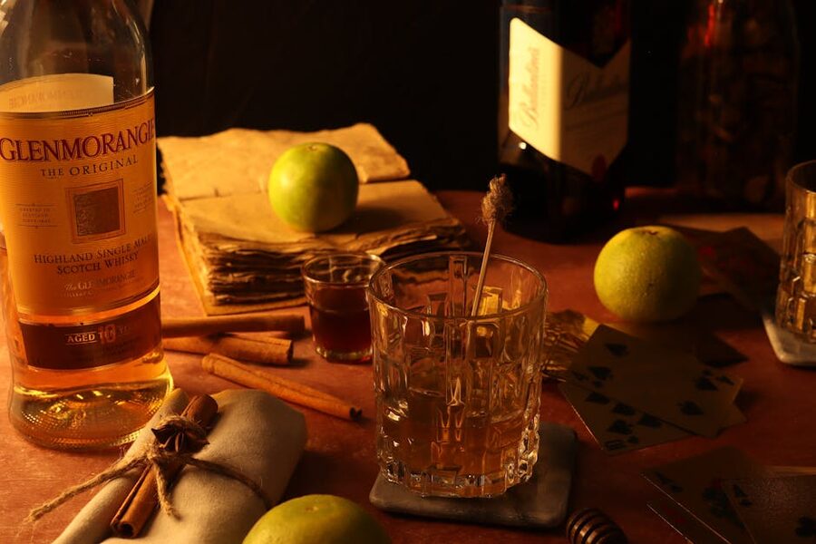 Whisky tumbler with apples by a fireplace