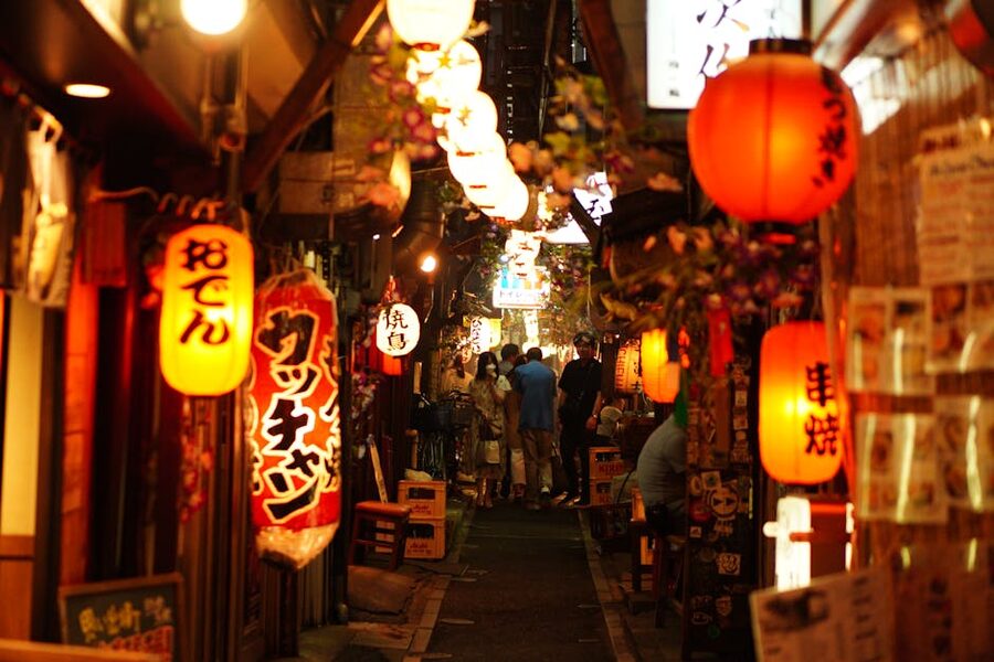 Narrow alley of Omoide Yokocho in Shinjuku at night with red lanterns