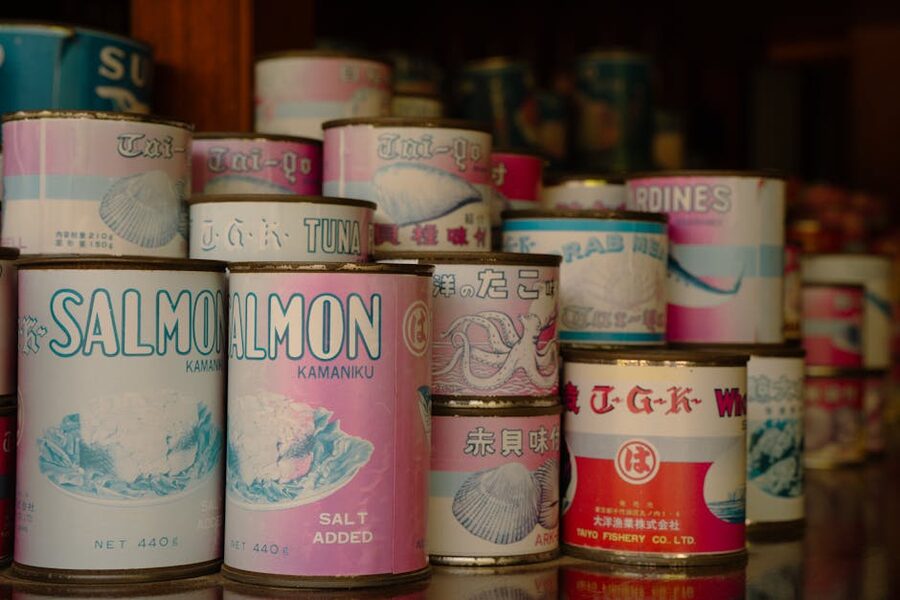 Vintage cans of Japanese seafood including salmon and tuna on a shop shelf