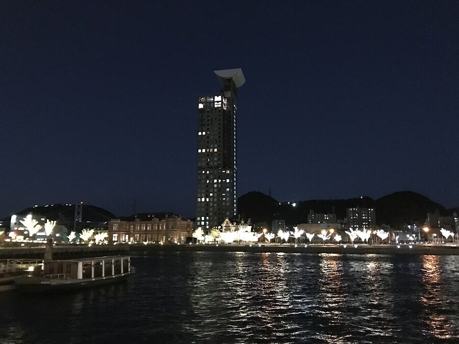 Mojiko Retro Highmart at night with port lights reflecting on water