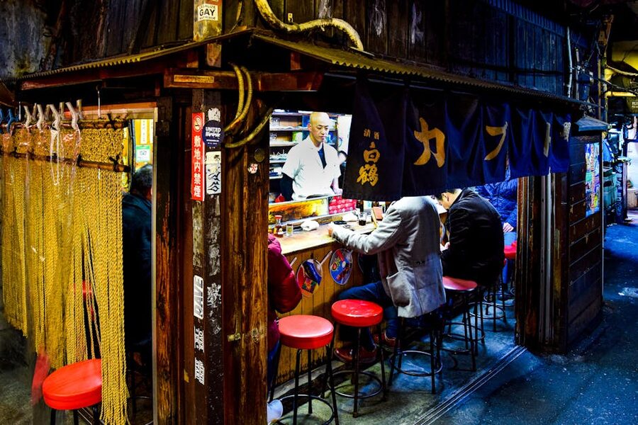Tokyo Omoide Yokocho nightlife alley with lanterns and people dining