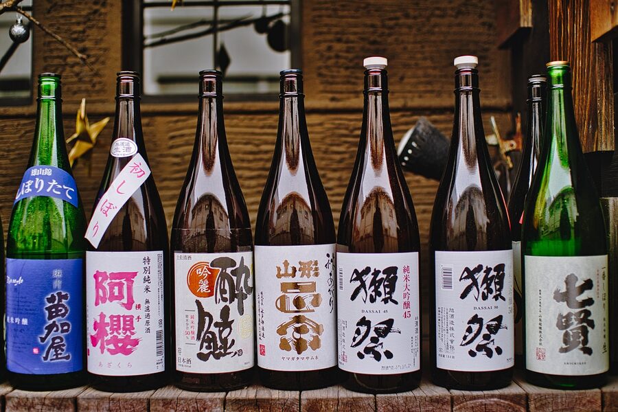 Sake being poured into glass cups in a Tokyo bar