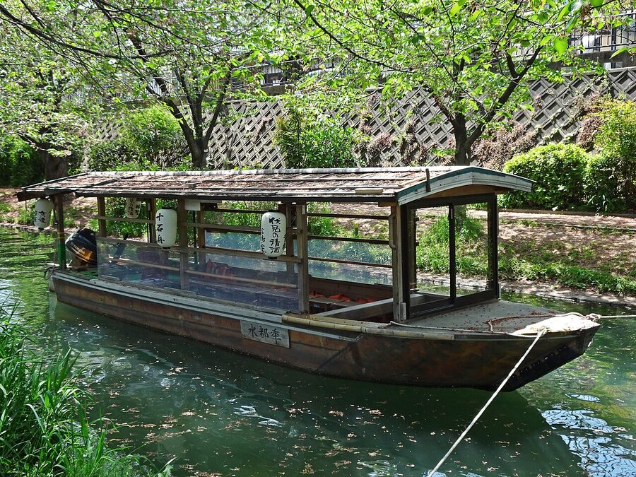 Jikkokubune flat-bottomed boat on a canal in Fushimi with passengers