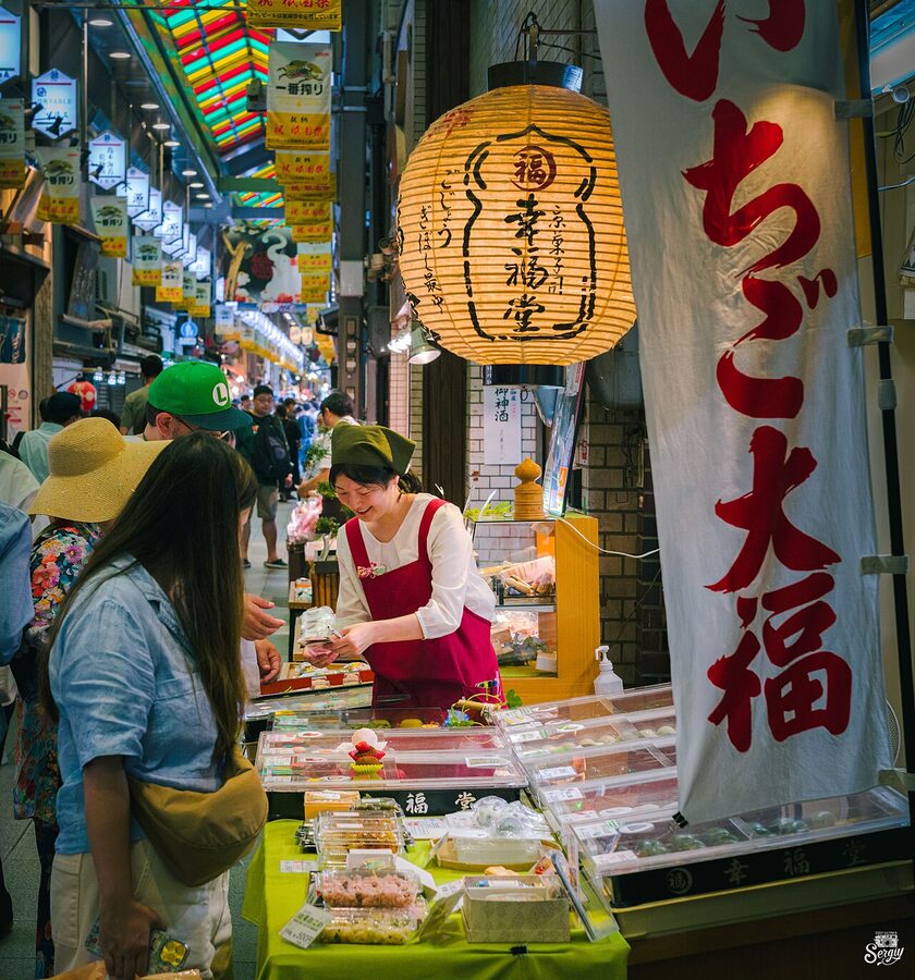 Nishiki Market arcade with shoppers and food stalls