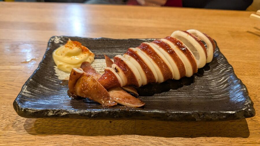Grilled squid on skewers at a Nishiki Market food stall