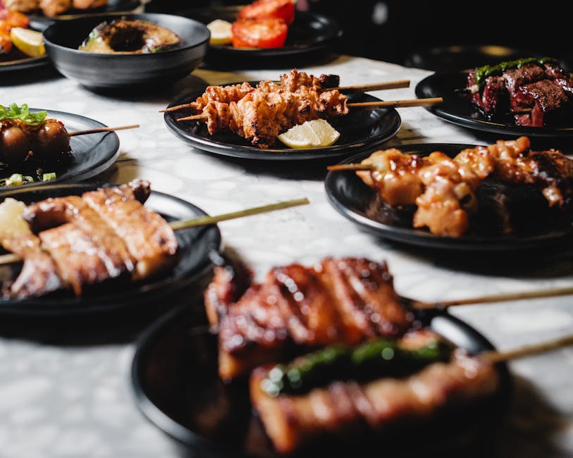 Yakitori chicken skewers being grilled over hot charcoal