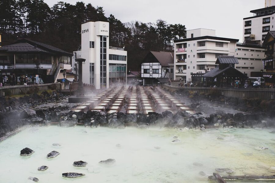 A tranquil hot spring town with steam rising from mineral-rich waters