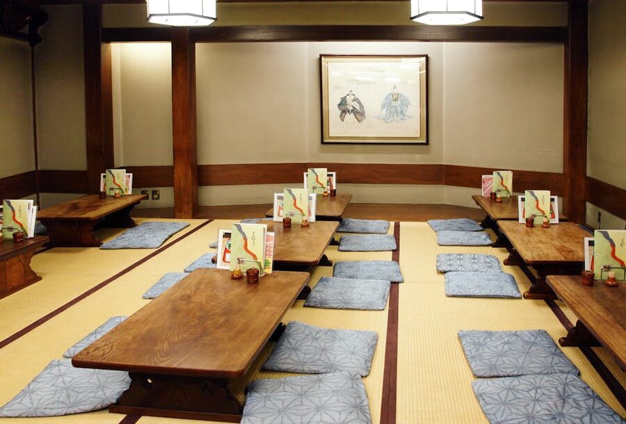 Beautifully arranged tatami room with low tables and cushions in a Japanese ryokan