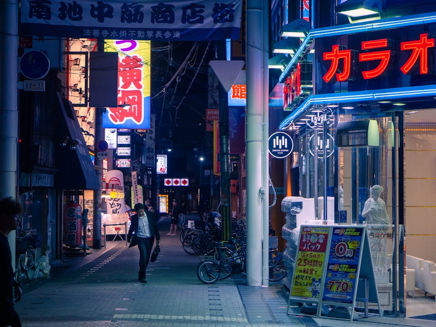 Neon-lit streets in Osaka at night with passersby