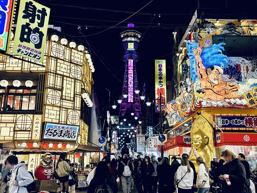 Shinsekai street with the Tsutenkaku tower at the end and traditional shopfronts