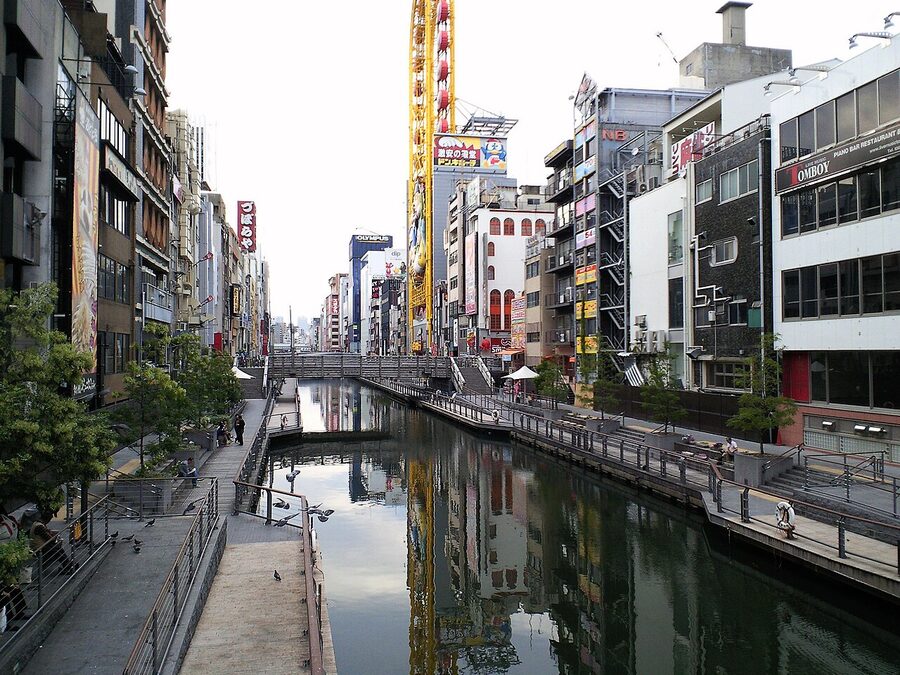 Tombori River Walk path along the Dotonbori canal in Osaka with crowds and signage