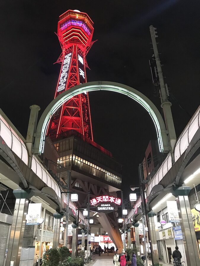 Tsutenkaku Hondori shopping street at night with tower in background