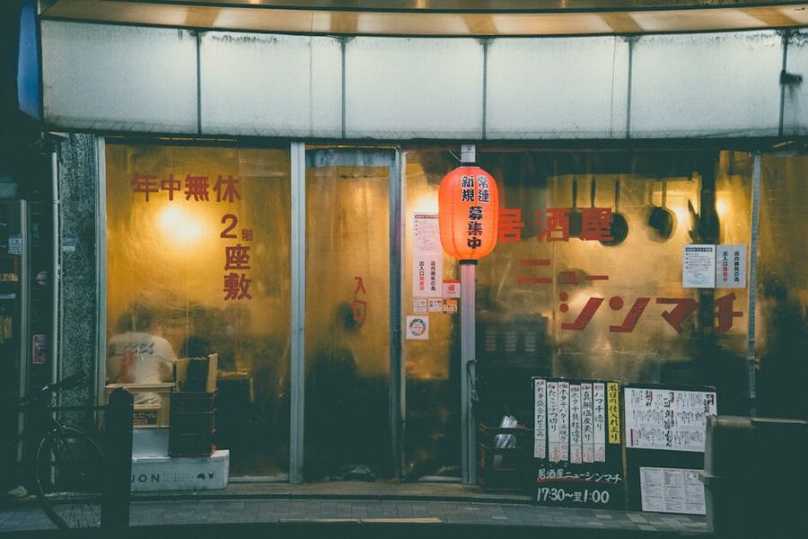 A traditional Kyoto izakaya with warm lantern light, busy on a December evening
