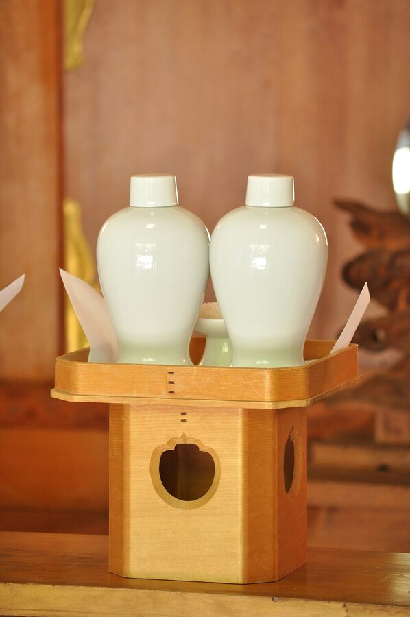 A shinsen offering at a Japanese Shinto shrine, including sake bottles for the kami