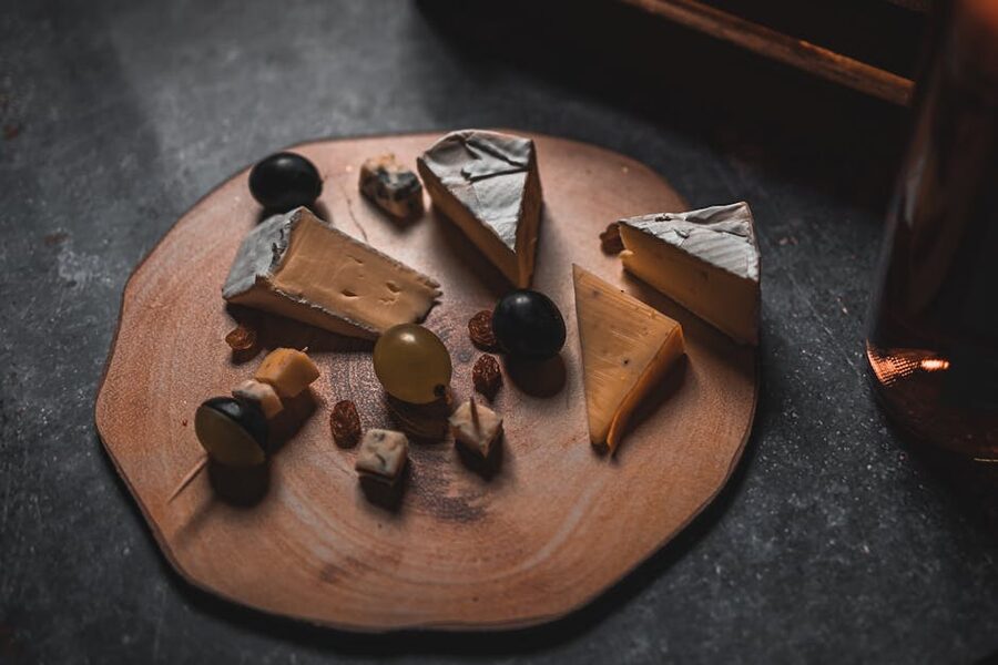 A rustic cheese platter with assorted cheeses, nuts, and grapes, the headline koshu pairing