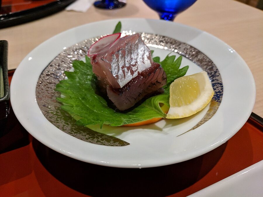 Flying fish sashimi served as part of the Course Yakushima dinner at JR Hotel Yakushima, paired with a chilled local ginjo