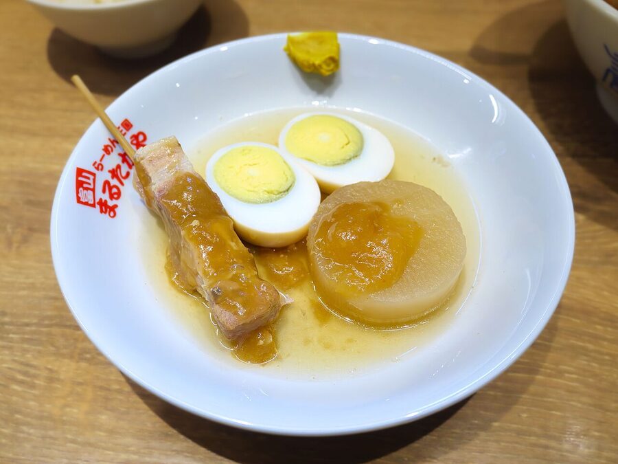 A bowl of oden at Marutakaya, a standing-room oden specialist near Toyama Station, with daikon, egg, and pork skewer