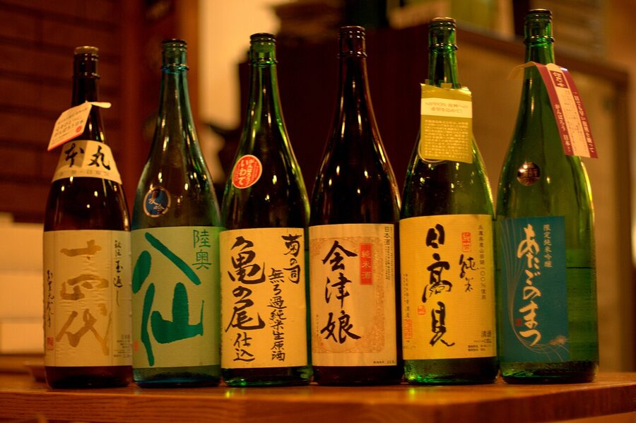 An array of Japanese sake bottles on a tasting table, the classic side-by-side flight setup