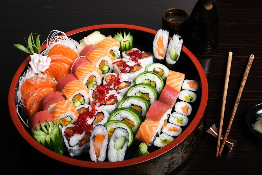 A platter of fresh sashimi presented with garnishes, the kind of light raw-seafood course that pairs naturally with chilled namazake