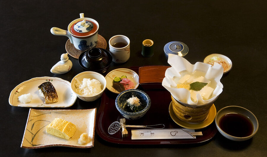 Breakfast at Tamahan Ryokan in Kyoto with grilled mackerel, dashi-braised vegetables, and yudofu in a paper pot