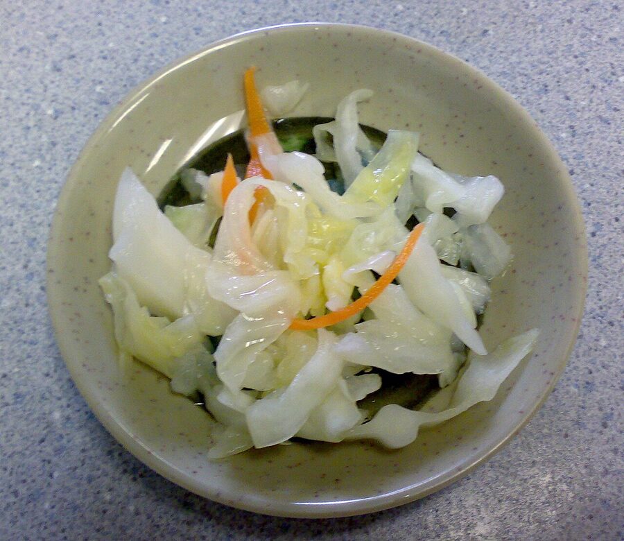 A dish of mixed Japanese tsukemono pickles, the kind of palate-cleansing side that builds a meal around honjozo