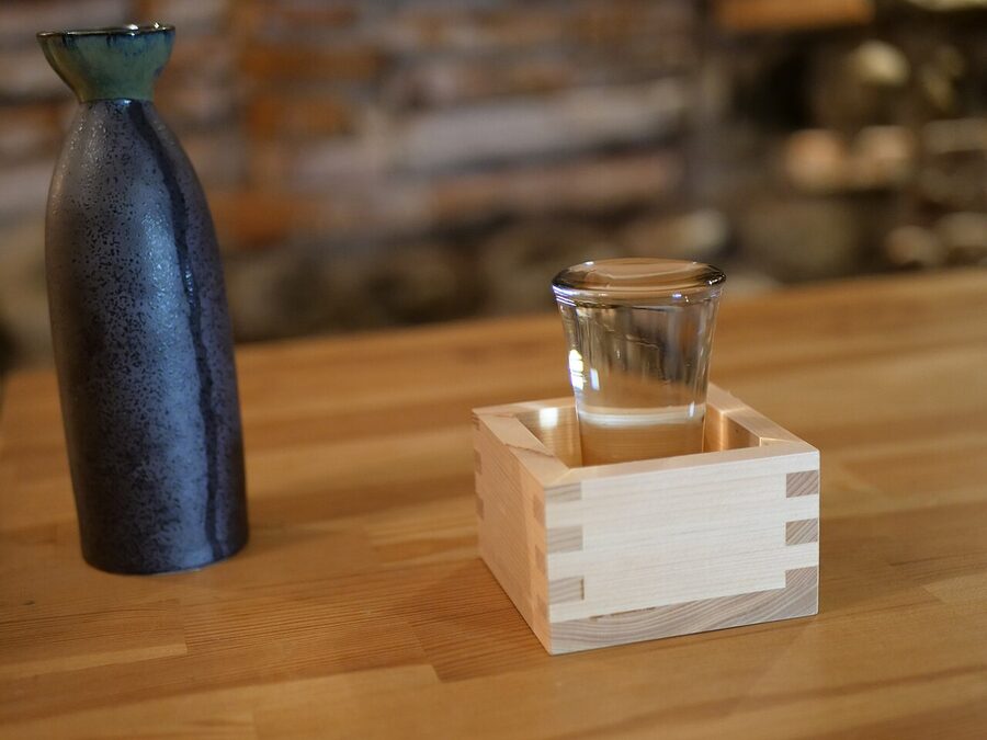 Sake glass and flask on a wooden table