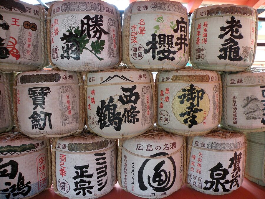 Sake cans with red labels stacked at Itsukushima