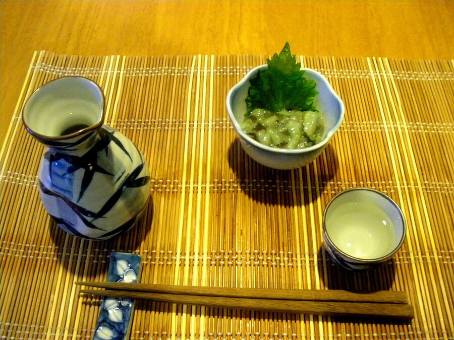 Tokkuri sake carafe with ochoko cup beside takowasa octopus dish