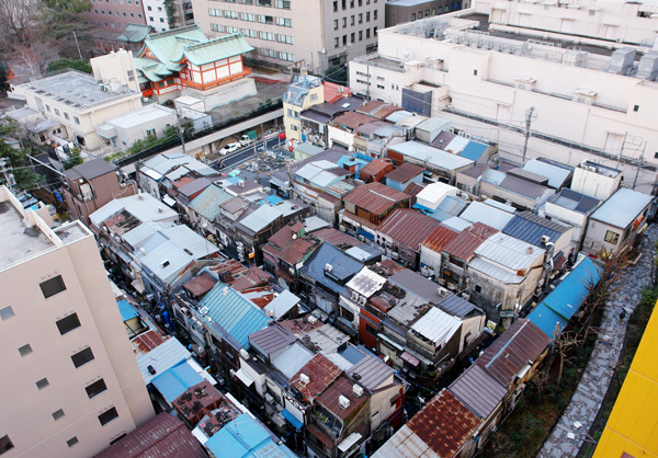 Shinjuku Golden Gai alleys during the day, doors and signage visible